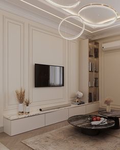 a living room filled with furniture and a flat screen tv mounted on a wall above a coffee table