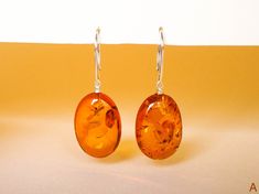 "Natural Baltic amber shiny cognac color oval earrings is a perfect choice for the classy and delicate style lovers. These handmade amber earrings add elegance to any look, so if this is what you are looking for - don't ignore an opportunity to get it! MATERIALS AND SIZE: Stone: 100% Natural Baltic Amber Findings: sterling silver 925 EARRINGS A: Weight: 5,2 g (0,18 oz) Bead size: 2,2 cm (0,86 in) x 1,6 cm (0,62 in) Total earring length: 4,3 cm (1,69 in) EARRINGS B: Weight: 5,3 g (0,18 oz) Bead s Jewelry Classy, Cognac Color, Oval Earrings, Amber Earrings, Natural Amber, Oval Earring, Amber Jewelry, Elegant Style, Cognac