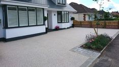 an empty driveway in front of a house