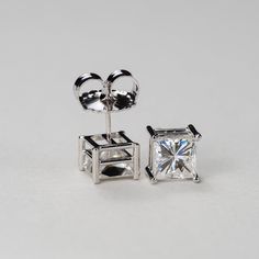 Our princess cut Charles & Colvard Forever One® colorless moissanite 4-prong stud earrings are a must have for every woman's jewelry box. Get the look and durability of diamonds, without the high cost and environmental footprint. Available in 14k, 18k yellow, white and rose gold as well as platinum. Choose desired metal and stone size from the drop-down menus before checkout. If you want these made with GIA certified diamonds, colored gemstones, or different moissanite shapes, please contact 14k White Gold Jewelry With Classic Cut, White Gold Asscher Cut Jewelry With Prong Setting, Asscher Cut White Gold Jewelry With Prong Setting, Classic Cut 14k White Gold Jewelry With Prong Setting, Fine Jewelry With Moissanite In Classic Cut, Fine Jewelry With Classic Cut Moissanite, Luxury Princess Cut Earrings For Gift, Classic Cut Cubic Zirconia Jewelry For Gifts, Diamond White Classic Cut 14k White Gold Jewelry