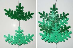 two pictures of green plastic snowflakes hanging from strings on a white wall, one is made out of legos and the other has buttons attached to a cord