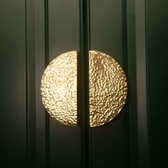 a close up of a door with a gold circle on the front and back panel