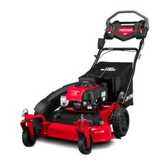 a red lawn mower sitting on top of a white surface with black trimming