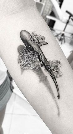 a black and white photo of a bird with feathers on it's back arm