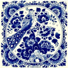 a blue and white plate with a bird on it