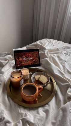 a tray that has some food on it and a laptop sitting on top of it