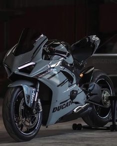 a silver motorcycle parked in front of a building