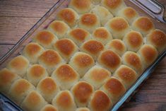 a casserole dish filled with lots of food on top of a wooden table