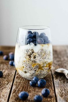 blueberries and yogurt in a glass on a wooden table