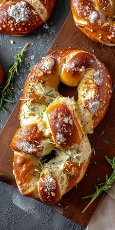 breads with cheese and herbs on a wooden cutting board next to other breads