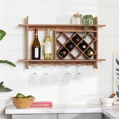 a wooden shelf with wine glasses and bottles on it