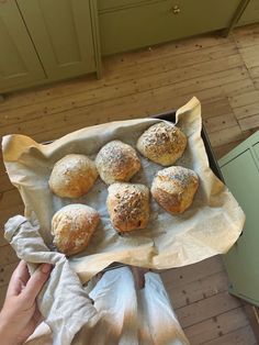 a person holding a tray filled with pastries