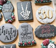 decorated cookies are displayed on a table for someone's 80th birthday party or special occasion