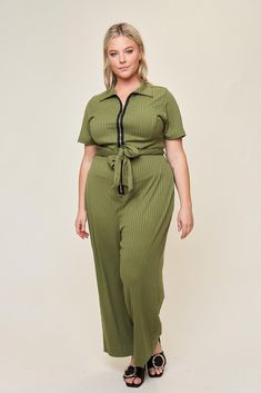 The "Lucia" jumpsuit is going to be your most-repeated piece ever. We're calling it. This jumpsuit is sewn in a high-quality knit rib that has a balance of stretch and sturdiness - making it perfect for a comfortable, yet tailored look.  When creating this jumpsuit, we decided to use a long, exposed zipper to add some character, as well as include a working belt + loops for added waist definition. Pair this jumpsuit with sneakers for work and pack your heels to take it from the office to happy h Jumpsuit With Sneakers, Sneakers For Work, Belted Jumpsuit, Belt Jumpsuit, Long Jumpsuits, Exposed Zipper, Green Pattern, Gold Zipper, Spandex Fabric