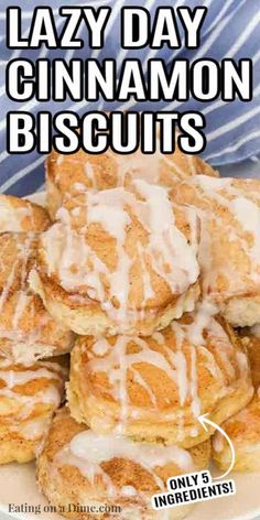 a pile of cinnamon biscuits sitting on top of a white plate covered in icing