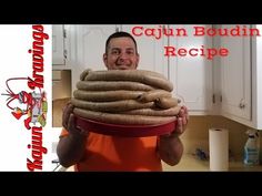 a man holding a bowl full of cooked sausages in front of his face with the caption cajun boudiin recipe