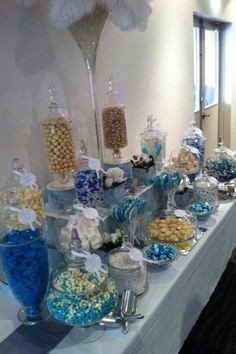 a table topped with lots of candy and candies on top of a white table cloth