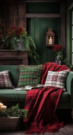 a living room with green walls and plaid pillows on the couch, surrounded by greenery