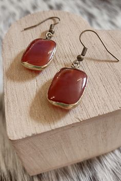 Step into the world of bold and vibrant fashion with our Sicily Red Agate Earrings! These stunning earrings are expertly handcrafted, ensuring that each pair is a one-of-a-kind masterpiece. The reddish orange agate stones exude an undeniable charm and sophistication, making them perfect for any occasion. Bronze Fishhook style finding Reddish orange Agate stone (each will vary in color) Approximately 1.5" in length All things ship for $3, all of the time Vibrant Fashion, Orange Agate, Reddish Orange, Agate Earrings, Red Agate, Stunning Earrings, Curated Gifts, Agate Stone, Gift Stickers