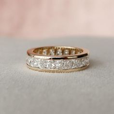 a wedding band with princess cut diamonds on it