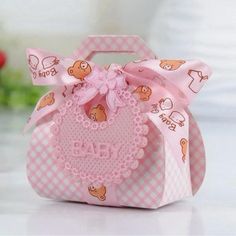 a small pink bag with a bow on the top and bear designs on it's side