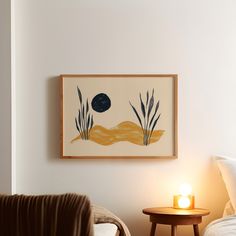 a painting hanging above a bed next to a night stand with a lit candle on it