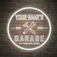 personalized garage neon sign with wrench and spanner on brick wall in dark room