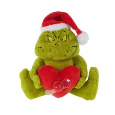 a green stuffed animal with a red heart