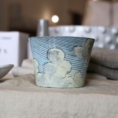 a blue and white cup sitting on top of a table