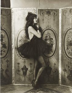 an old photo of a woman in a black dress