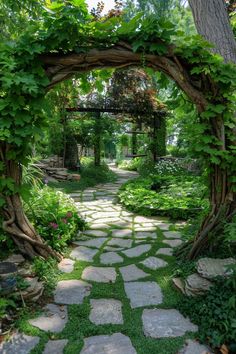 a stone path through a lush green garden