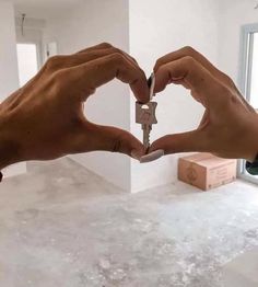 two hands holding keys in the shape of a heart