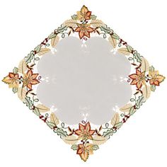 a white plate with an ornate design on the front and back side, surrounded by leaves and flowers