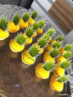 small pineapples are arranged on a clear plate