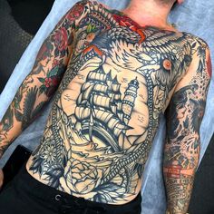 a man with lots of tattoos on his back