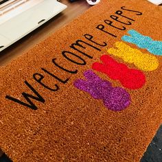 a welcome mat with the words welcome here on it