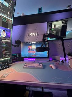 a computer desk topped with two monitors and a keyboard