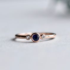 Genuine sapphire-adorned three stone ring. 14k Rose gold fully hallmarked 3mm blue Sapphire center stone. 1.75mm White Sapphires Approx 1.5mm band width FREE SHIPPING USA- All of our jewelry will arrive in custom packaging ready for gift giving. LEAD TIME: Made to order will take 10-14 days. Signature upon delivery, we unfortunately will not be able to reimburse or replace lost or stolen shipments. FOLLOW US ON: Instagram: @roseandchoc Facebook: /Roseandchoc Pinterest: @Roseandchoc Ring Stacking Ideas, Trio Ring, Promise Ring Gift, Blue Sapphire Ring, Birthday Ring, Gold Filled Ring, Blue Sapphire Rings, Three Stone Rings, Delicate Rings