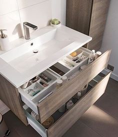 a bathroom with a sink and drawers in it