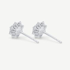 The floral cluster earrings are crafted in 18k solid white gold and set with 34 earth-mined round diamonds with an average carat weight of 0.40 carats. Luxury Silver Diamond Flower Earrings, White Diamond Flower Earrings With Brilliant Cut, Diamond Flower Shaped Earrings For Formal Occasions, Diamond Flower Shaped Earrings For Formal Events, Formal Diamond Earrings With Flower Shape, Diamond White Flower-shaped Diamond Earrings, Diamond Flower-shaped Earrings With Brilliant Cut, Elegant Round Cluster Earrings With Lab Grown Diamonds, Elegant Lab Grown Diamond Cluster Earrings As Gift