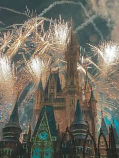 fireworks are lit up in the sky above a castle