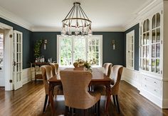 a dinning room table with chairs and a chandelier