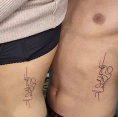 two people with tattoos on their stomachs