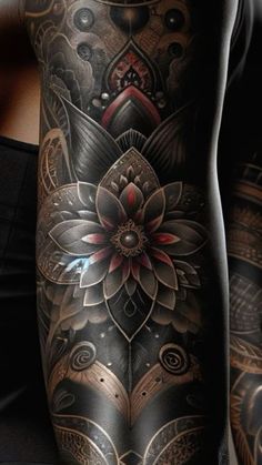 a woman with tattoos on her arm and leg is wearing a black tank top that has an intricate flower design