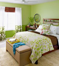 a bedroom with green walls, white curtains and a bed in the middle is shown