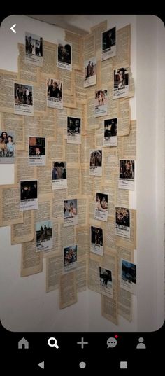 an open book with pictures on it and some papers pinned to the wall behind it