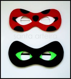 two masks with green eyes and black eyeliners, one is red and the other is black