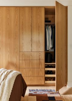 a bedroom with wooden closets and an area rug that matches the carpeting on the floor