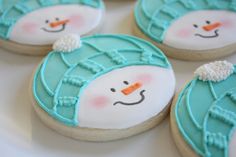 four decorated cookies with frosting on them