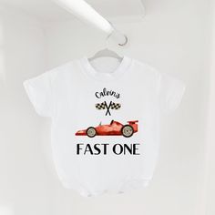 "This first birthday design includes a race car and text \"fast one\" and is available in 8 different product types. The design is printed on 100% cotton on either a short sleeve bodysuit, long sleeve bodysuit, sweatshirt romper, sleeper, or toddler sweatshirt, long sleeve, or short sleeve. This piece is a sturdy material, cozy soft and perfect for staying cuddly. Perfect for your babe's bday celebration. Sizing: long and short sleeves: true to size sweatshirt romper and sweatshirt: oversized sleeper: fits large sweatshirt: slightly oversized but more true to size This product is handprinted using nontoxic, water-based inks on a cotton sweatshirt material romper with three snaps. This item comes in the following infant sizes  3-6 months 6-12 months 12-18 months 18/24 months 2T Gentle cycle Sweatshirt Romper, Bday Celebration, Race Car Birthday, First Birthday Shirts, First Birthday Outfit, Car Birthday, Sweatshirt Oversized, 1st Birthday Outfits, First Birthday Outfits